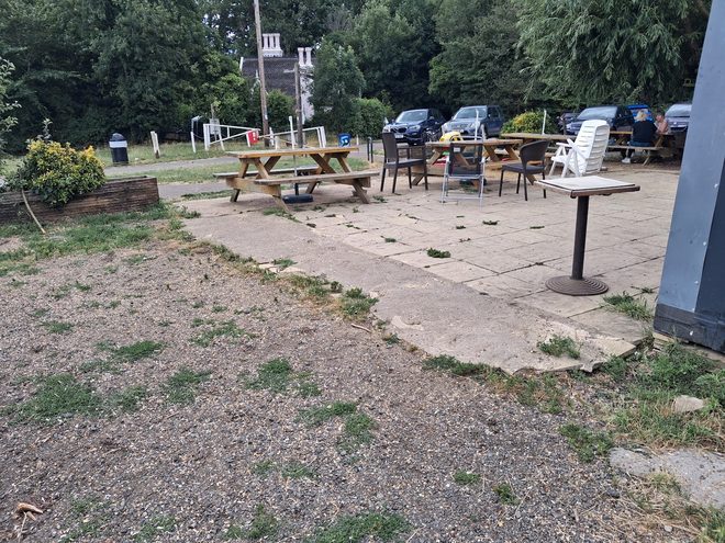 Picnic tables on the paved seating area